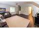 Inviting living room featuring a sectional sofa, neutral rug, and multiple windows for ample natural light at 5025 Martin Farm Rd, Raleigh, NC 27613