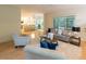 Open concept living space with a view of the kitchen, hardwood floors, and comfortable seating at 5025 Martin Farm Rd, Raleigh, NC 27613