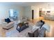 Cozy living room with fireplace, seating, and view of the kitchen at 5025 Martin Farm Rd, Raleigh, NC 27613