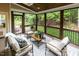 Inviting screened porch with cozy furniture and a serene view of the backyard greenery at 5025 Martin Farm Rd, Raleigh, NC 27613