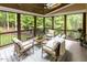 Relaxing screened porch with comfortable seating, a stylish rug, and a view of the lush backyard at 5025 Martin Farm Rd, Raleigh, NC 27613