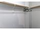 Simple closet featuring a wooden rod and shelf for organizing clothing and accessories at 5025 Martin Farm Rd, Raleigh, NC 27613