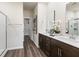 Bathroom featuring double sinks, granite counters, wood cabinets, and a glass enclosed shower at 648 White Birch Ln, Angier, NC 27501