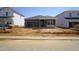 New home construction with a blue facade, featuring an open garage and a partially landscaped yard at 648 White Birch Ln, Angier, NC 27501