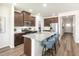 Modern kitchen features a large island with seating and stainless steel appliances at 648 White Birch Ln, Angier, NC 27501