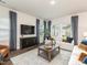 Cozy living room with plush sofas, modern decor, and a large flat-screen TV at 648 White Birch Ln, Angier, NC 27501