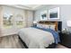 Bright main bedroom featuring large windows, plush bedding, and tasteful decor at 648 White Birch Ln, Angier, NC 27501