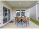 Cozy covered patio with a stylish dining set and sliding glass door access to the home's interior at 648 White Birch Ln, Angier, NC 27501