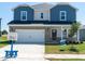 Charming two-story home featuring a brick and siding facade, two-car garage, and well-manicured lawn at 658 White Birch Ln, Angier, NC 27501