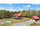 Stunning aerial view featuring a beautiful log cabin home with a pool, detached garage and large lot at 6707 Frieden Church Rd, Gibsonville, NC 27249