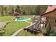 Aerial view of a beautiful backyard, swimming pool, hot tub, and deck on log cabin home at 6707 Frieden Church Rd, Gibsonville, NC 27249