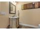 Elegant powder room features a decorative vanity, neutral paint, and modern fixtures at 6707 Frieden Church Rd, Gibsonville, NC 27249