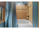 Stylish bathroom with tiled shower and tub combination with blue curtain at 6707 Frieden Church Rd, Gibsonville, NC 27249