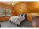 Upstairs bedroom with carpet flooring, wood ceilings and walls, plus a double bed at 6707 Frieden Church Rd, Gibsonville, NC 27249