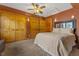 Bedroom with hardwood doors, overhead fan, carpet, and king bed at 6707 Frieden Church Rd, Gibsonville, NC 27249