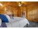 Well-lit upstairs bedroom with wooden ceilings and walls, plus carpet flooring and a bed at 6707 Frieden Church Rd, Gibsonville, NC 27249
