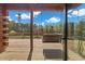 Relaxing outdoor deck featuring a comfortable swing with a view of the lush greenery and blue sky at 6707 Frieden Church Rd, Gibsonville, NC 27249