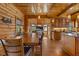 Cozy dining room with wood walls, large windows, and open to the gourmet kitchen at 6707 Frieden Church Rd, Gibsonville, NC 27249