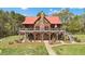 Stunning log home with stone accents, large deck, and beautifully landscaped yard at 6707 Frieden Church Rd, Gibsonville, NC 27249