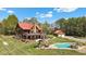 Expansive home exterior showcasing the in-ground pool, outdoor kitchen, and guest house at 6707 Frieden Church Rd, Gibsonville, NC 27249