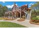 Exterior view showcasing the large deck, stone facade, and landscaped yard at 6707 Frieden Church Rd, Gibsonville, NC 27249