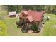 Charming log home with a red roof, a detached garage, and well-maintained landscaping at 6707 Frieden Church Rd, Gibsonville, NC 27249