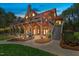 Stunning log home with an expansive stone patio, outdoor grill, and inviting backyard space at 6707 Frieden Church Rd, Gibsonville, NC 27249