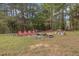 Enjoy this outdoor space with fire pit and chairs surrounded by mature trees to gather around and enjoy the outdoors at 6707 Frieden Church Rd, Gibsonville, NC 27249