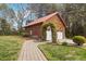Two car garage with arched flowered entrance, matching the style of the house at 6707 Frieden Church Rd, Gibsonville, NC 27249