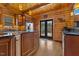 Kitchen with wood walls and floors, stainless steel appliances, granite countertops and a view of the outdoors at 6707 Frieden Church Rd, Gibsonville, NC 27249