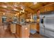 Spacious wood kitchen with wooden ceilings, cabinets, floors, and stainless steel appliances at 6707 Frieden Church Rd, Gibsonville, NC 27249