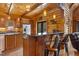 Gourmet kitchen with wood cabinets, granite countertops, stainless appliances, and bar seating at 6707 Frieden Church Rd, Gibsonville, NC 27249