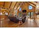 Cozy living room featuring vaulted ceilings, a stone fireplace, hardwood floors, and comfortable leather seating at 6707 Frieden Church Rd, Gibsonville, NC 27249