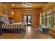Comfortable main bedroom with wooden walls, ceilings, and floors, plus a king bed and outdoor views at 6707 Frieden Church Rd, Gibsonville, NC 27249