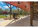 Relaxing outdoor space with covered patio, grill, and view of the lush backyard and pool at 6707 Frieden Church Rd, Gibsonville, NC 27249