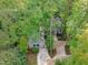 Aerial view showcases the charming home surrounded by lush trees at 7116 Asheway Dr, Holly Springs, NC 27540