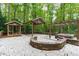 A backyard featuring a hot tub, a gazebo, and a covered area, all on a beautiful stone patio at 7116 Asheway Dr, Holly Springs, NC 27540