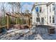 Inviting backyard patio features a charming pergola-covered hot tub and stone surround at 7116 Asheway Dr, Holly Springs, NC 27540
