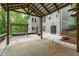 Backyard with hot tub, a gazebo, a covered patio, and stone patio, next to a home with gray siding at 7116 Asheway Dr, Holly Springs, NC 27540