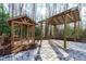 Inviting backyard patio with stone flooring, gazebo, and covered structure, perfect for outdoor entertaining at 7116 Asheway Dr, Holly Springs, NC 27540