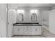 Large bathroom featuring dual sinks, cabinets, mirrors, and fresh paint at 7116 Asheway Dr, Holly Springs, NC 27540