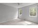 Neutral bedroom with large windows providing natural light and a ceiling fan at 7116 Asheway Dr, Holly Springs, NC 27540