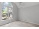Light-filled bedroom with carpet, a ceiling fan, and a large window with a backyard view at 7116 Asheway Dr, Holly Springs, NC 27540