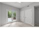 Bright bedroom offers a ceiling fan, closet space, and access to the outdoor patio at 7116 Asheway Dr, Holly Springs, NC 27540