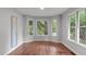 Cozy bonus room with wood floors, a large bay window, and neutral walls at 7116 Asheway Dr, Holly Springs, NC 27540