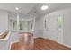 Bright entryway featuring wood floors, neutral paint, and lots of windows and natural light at 7116 Asheway Dr, Holly Springs, NC 27540