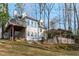 Charming home exterior with large windows, a spacious deck, and a hot tub in the back yard at 7116 Asheway Dr, Holly Springs, NC 27540