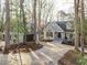 Charming grey house with a two-car garage, surrounded by mature trees and a long driveway at 7116 Asheway Dr, Holly Springs, NC 27540