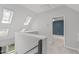 Light and airy hallway featuring skylights, fresh paint, and neutral carpeting at 7116 Asheway Dr, Holly Springs, NC 27540