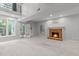 The spacious living room includes a brick fireplace, recessed lighting, and large windows at 7116 Asheway Dr, Holly Springs, NC 27540
